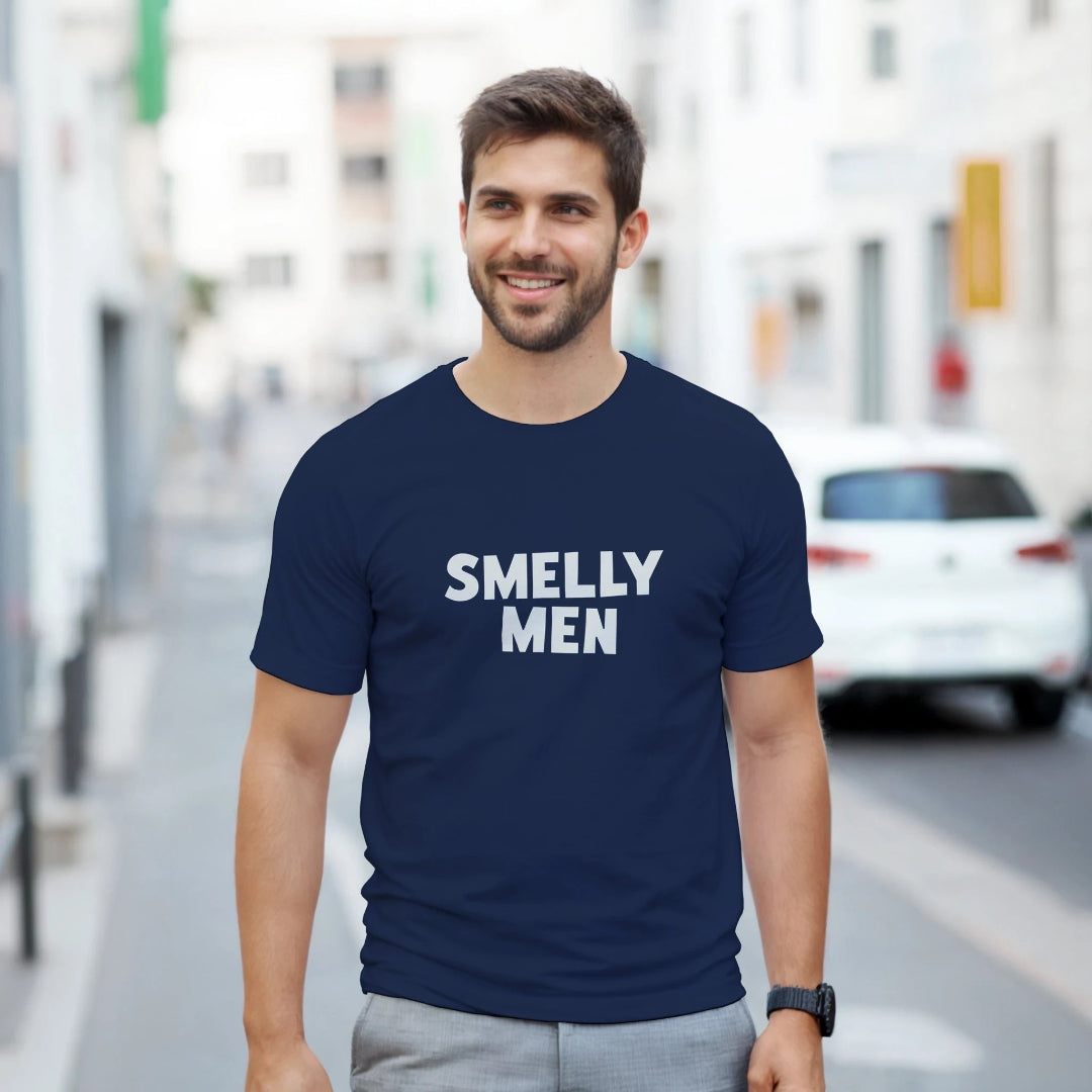 Man wearing a navy blue t-shirt with 'SMELLY MEN' text on a city street.
