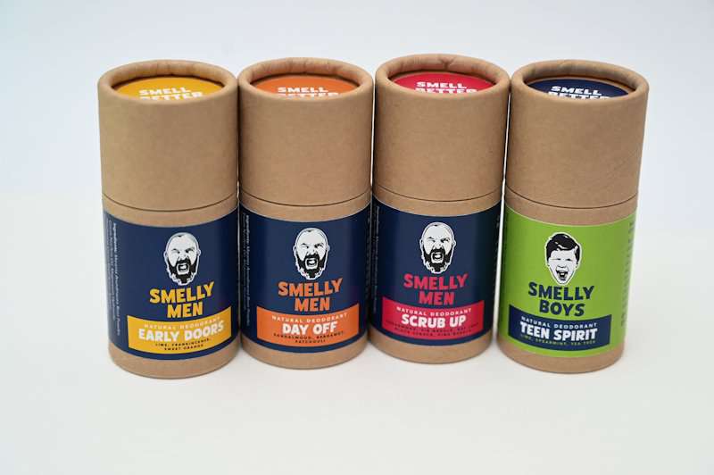 Four Smelly Men natural deodorant tubes for men on a white background