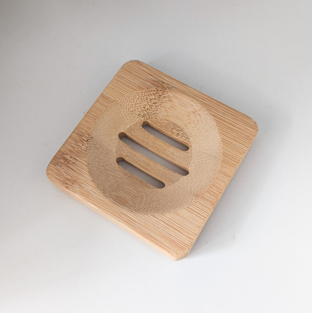 Wooden soap dish with a textured surface on a white background