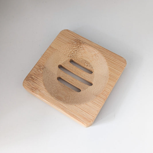 Wooden soap dish with a textured surface on a white background