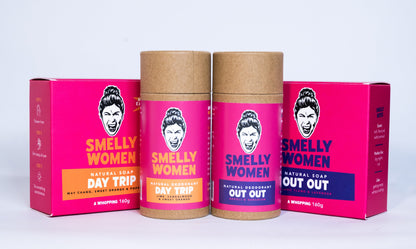Four containers of 'Smelly Women' natural soap and deodorant on a white background