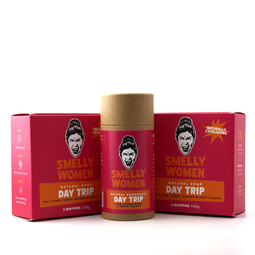 Smelly Women Day Trip natural soap and deodorant set, featuring a kraft paper stick container in the center flanked by two matching red boxes on a white background.