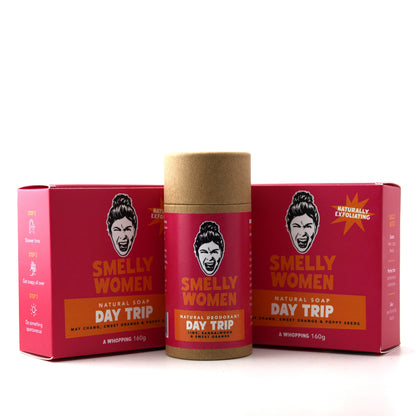 Smelly Women Day Trip natural soap and deodorant set, featuring a kraft paper stick container in the center flanked by two matching red boxes on a white background.