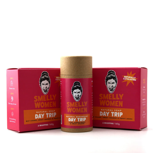 Smelly Women Day Trip natural soap and deodorant set, featuring a kraft paper stick container in the center flanked by two matching red boxes on a white background.