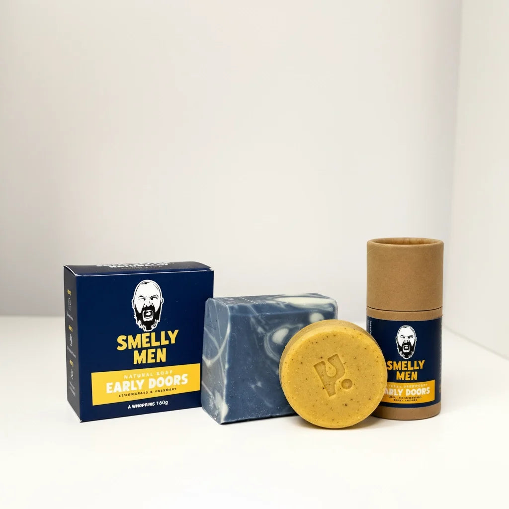 Collection of 'Smelly Men' products including a bar of soap, a soap carton, and a deodorant tube on a white background.