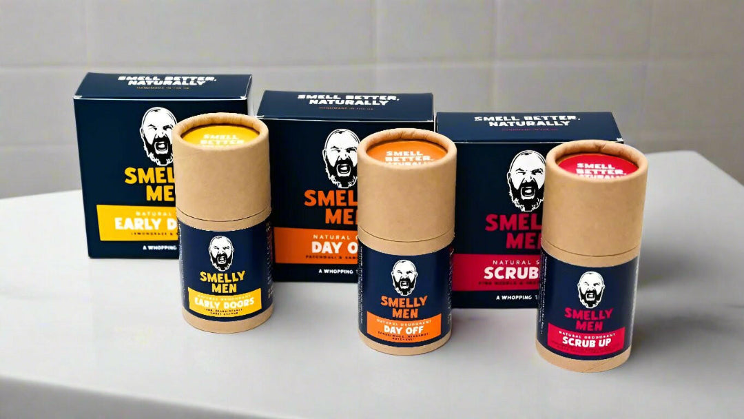 Three soap cartons and three deodorant tubes on a bathroom counter