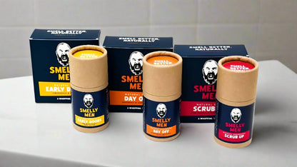 Three soap cartons and three deodorant tubes on a bathroom counter