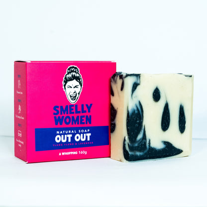 Bar of soap with black and white swirls next to a pink 'Smelly Women' packaging on a white background
