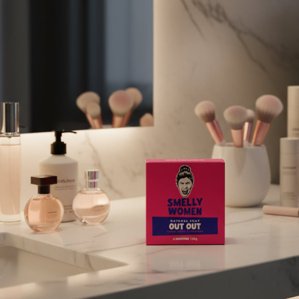 Pink and blue soap packaging with a face illustration on a white background