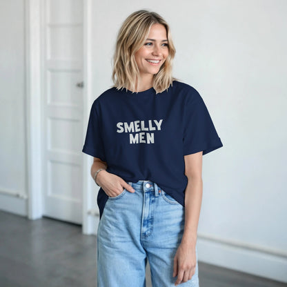 Woman wearing a navy blue t-shirt with 'SMELLY MEN' text in a room.