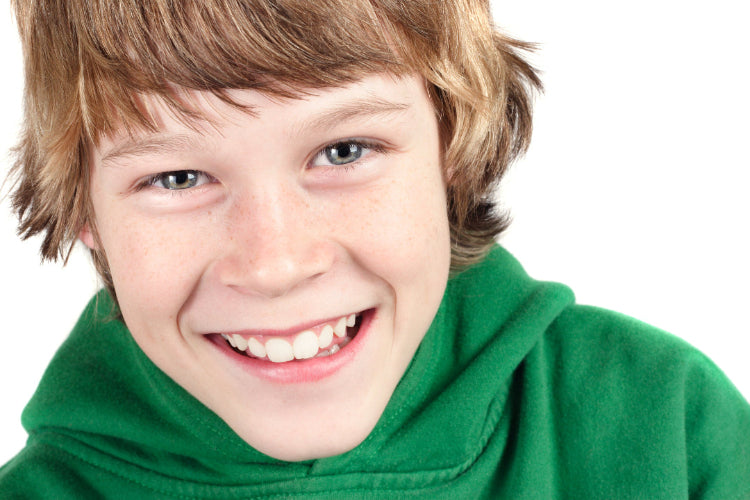 Close-up of a young person wearing a green hoodie on a white background