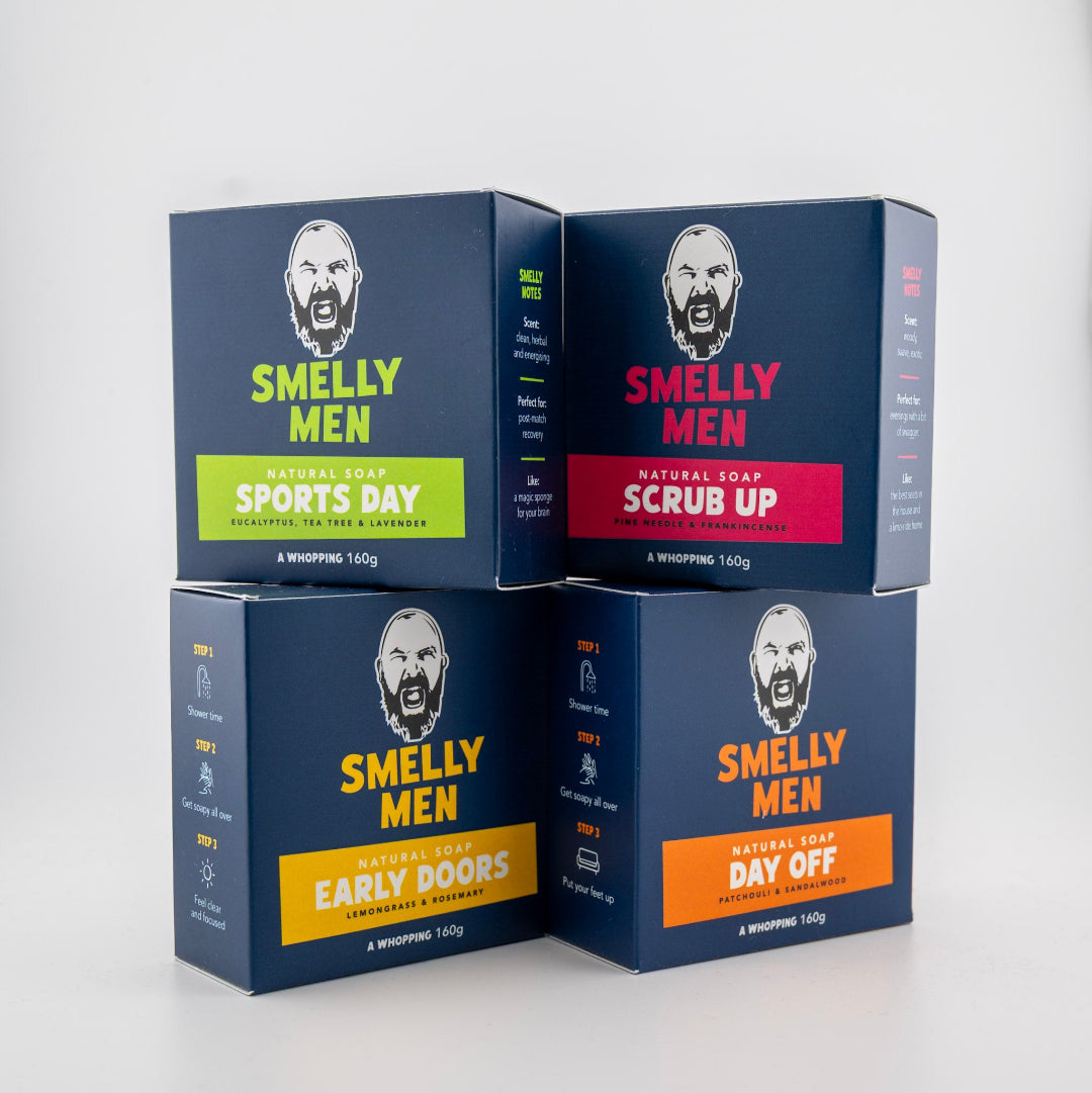 Four boxes of 'Smelly Men' soap with different scents on a white background