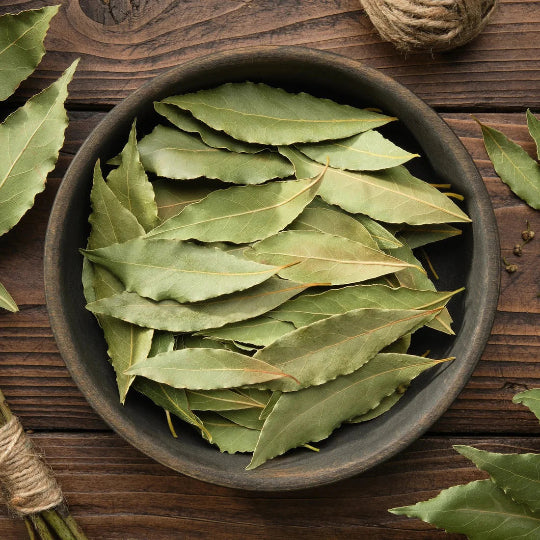 bay leaves in a wooden bowl on a wooden table