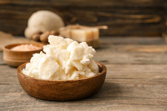 Shea butter in a wooden bowl on a table