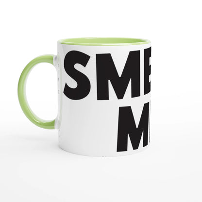 White mug with green handle and black text on a white background
