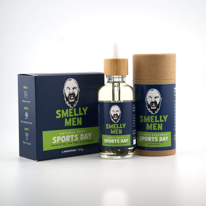 A bottle of Smelly Men Sports Day Shave Serum, a matching natural soap and a matching cardboard tube deodorant with a navy label, placed on a clean white background.