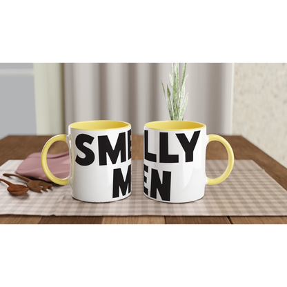 Two mugs with yellow interior and exterior, black text on a wooden table.